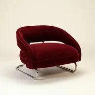 Oxblood velvet lounge chair with a chrome sled base
